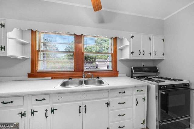 kitchen featuring ceiling fan, white cabinets, crown molding, sink, and gas range gas stove