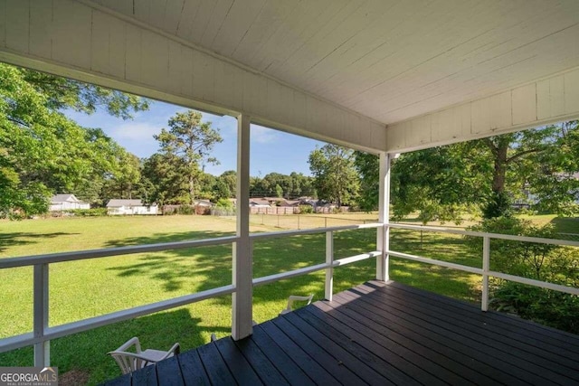 wooden terrace featuring a lawn