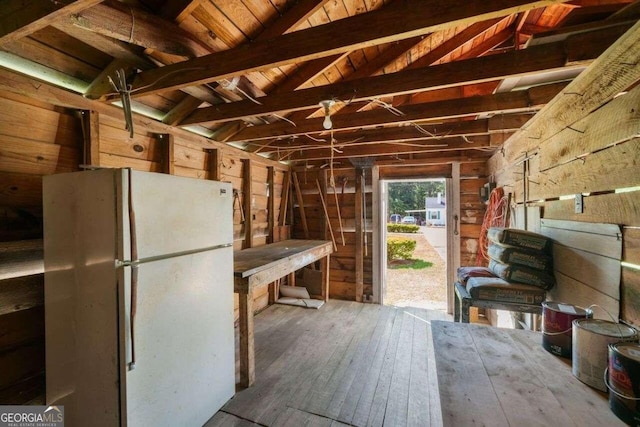 misc room with wood walls, wood-type flooring, lofted ceiling with beams, and wood ceiling