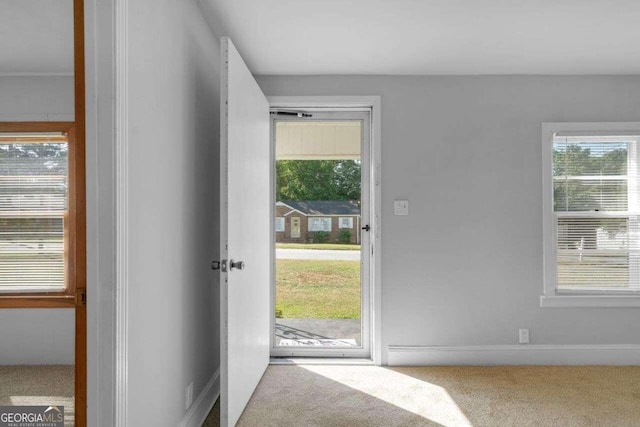 doorway to outside with carpet