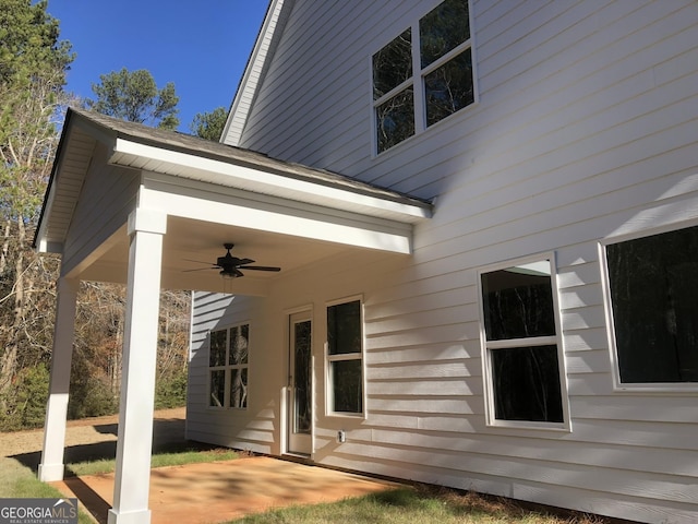 view of side of property with ceiling fan