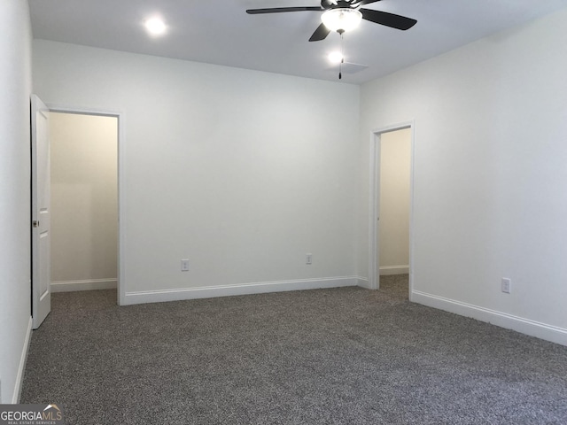 unfurnished room featuring dark colored carpet and ceiling fan