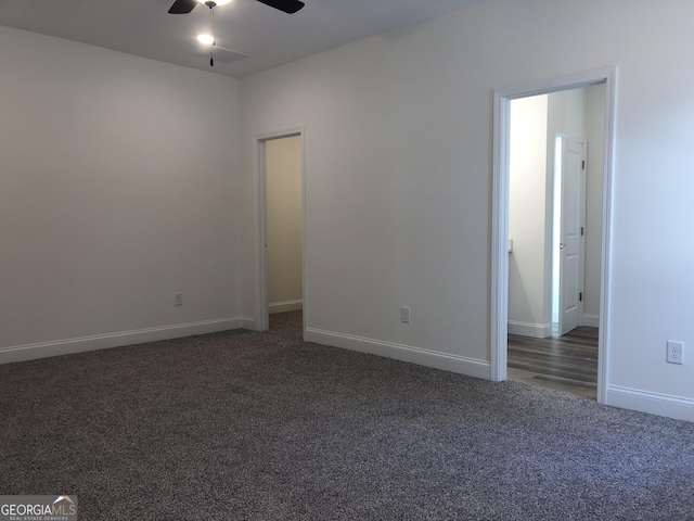 empty room featuring dark colored carpet and ceiling fan