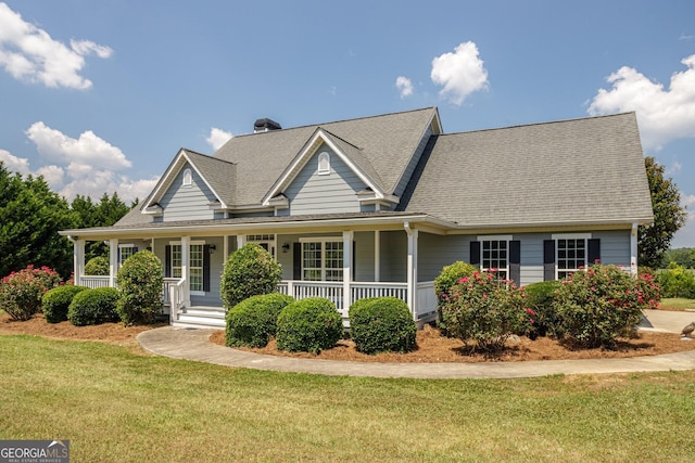 view of front of home featuring covered porch and a front lawn