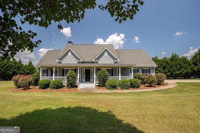 view of front of property featuring covered porch and a front yard