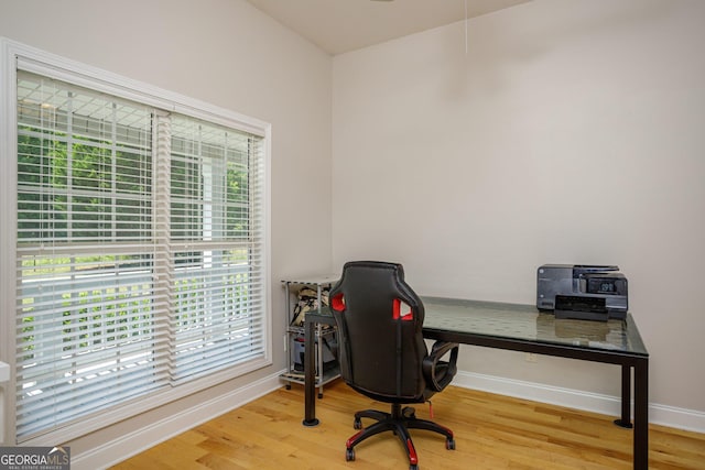 home office with a healthy amount of sunlight and wood-type flooring