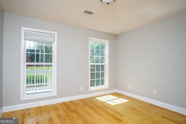 unfurnished room with hardwood / wood-style floors