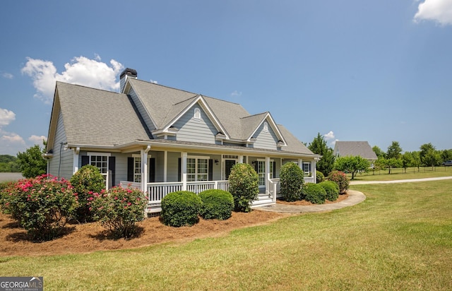 view of front of house featuring covered porch and a front yard