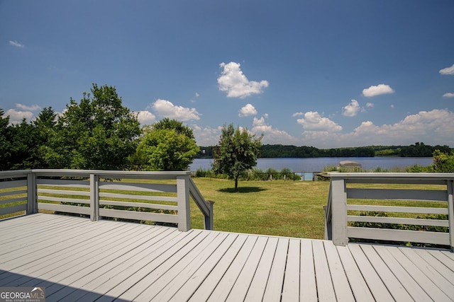 wooden terrace featuring a yard and a water view