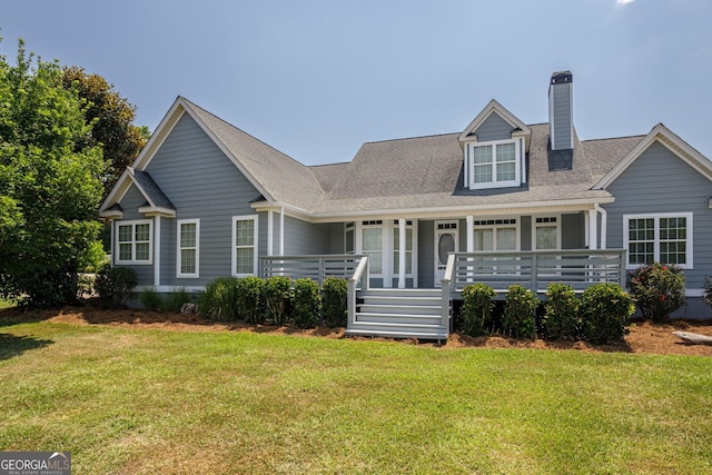 view of front of house featuring a front lawn and a wooden deck