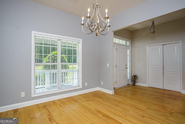 entrance foyer featuring wood-type flooring and a notable chandelier