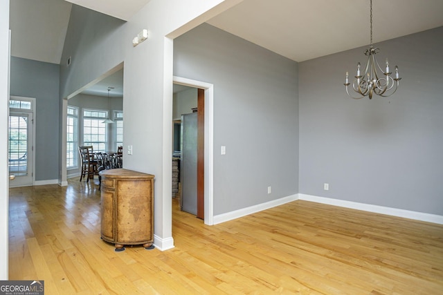 dining room featuring hardwood / wood-style floors and an inviting chandelier