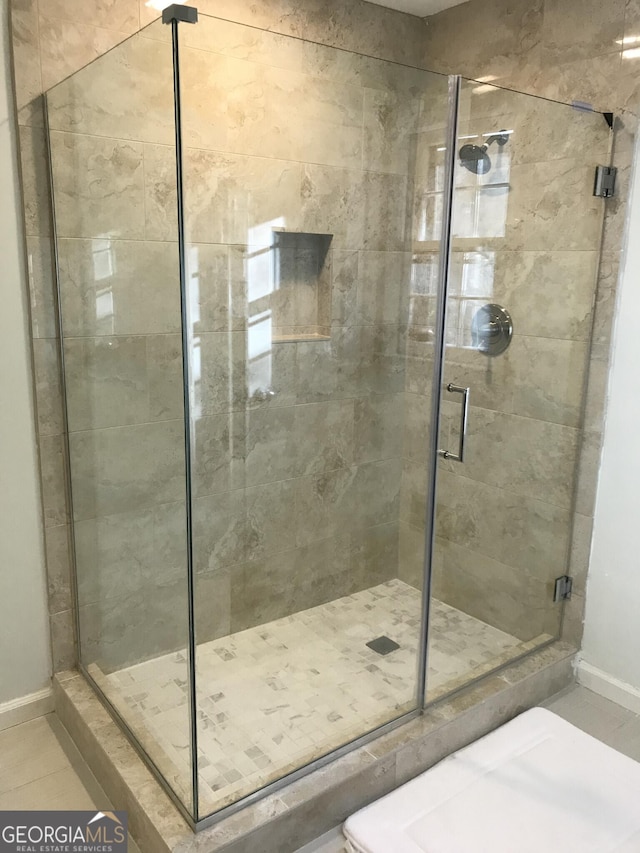 bathroom featuring tile flooring and walk in shower