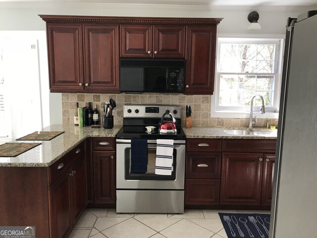 kitchen with tasteful backsplash, stainless steel appliances, light tile flooring, light stone counters, and sink