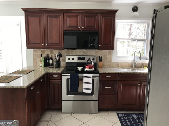 kitchen featuring tasteful backsplash, sink, light tile patterned floors, and stainless steel appliances