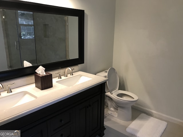 bathroom featuring vanity, toilet, and an enclosed shower