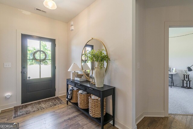 view of carpeted foyer entrance