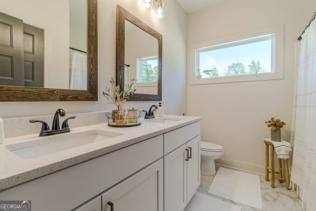 bathroom featuring tile patterned floors, dual bowl vanity, and toilet