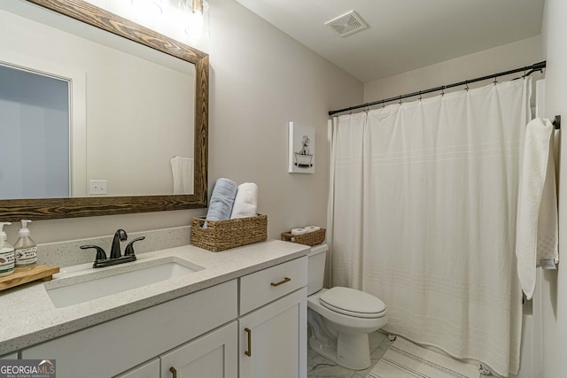 bathroom with vanity, tile patterned flooring, and toilet