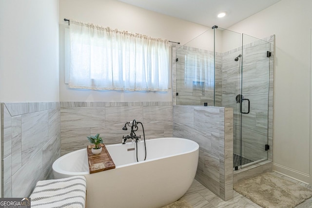 bathroom with independent shower and bath, tile walls, and tile patterned floors