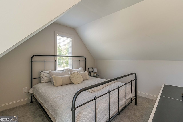 bedroom with lofted ceiling and dark carpet