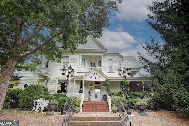 view of front of house with covered porch and a balcony