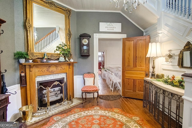 sitting room with ornamental molding, a healthy amount of sunlight, a fireplace, and hardwood / wood-style floors