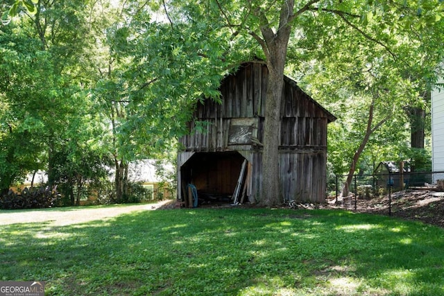 view of outbuilding featuring a yard