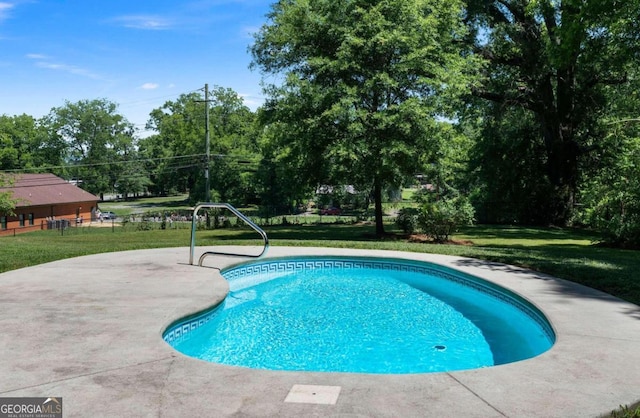 view of pool featuring a patio area and a yard