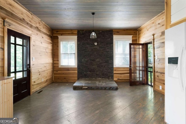 interior space with french doors, dark hardwood / wood-style flooring, wood ceiling, and wood walls