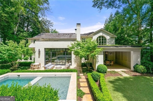 rear view of property featuring a yard and a patio