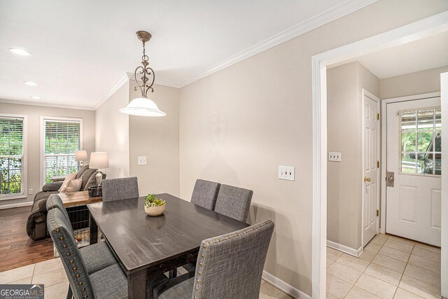 tiled dining room featuring ornamental molding