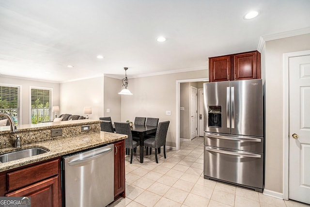 kitchen with light stone countertops, sink, pendant lighting, appliances with stainless steel finishes, and ornamental molding