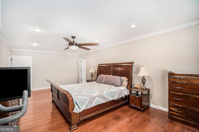 bedroom featuring ceiling fan, wood-type flooring, and crown molding