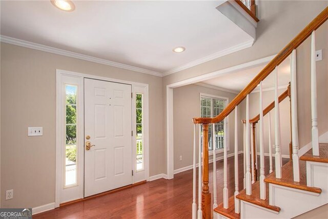 entryway featuring hardwood / wood-style floors and ornamental molding