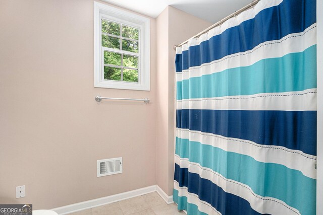 bathroom with a shower with curtain