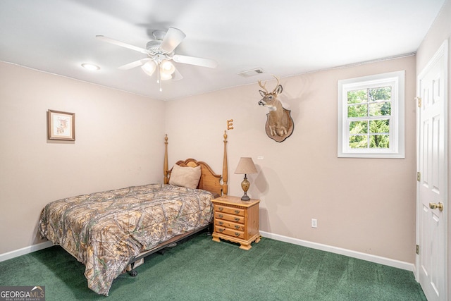 bedroom with ceiling fan and dark carpet