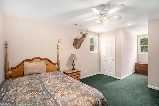 bedroom with dark colored carpet and ceiling fan