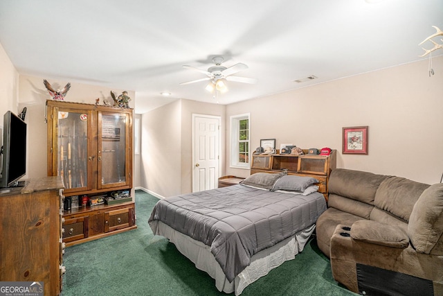 bedroom featuring ceiling fan and dark carpet