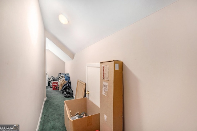 hall featuring carpet floors and lofted ceiling