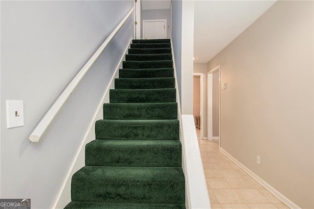 staircase with tile patterned flooring