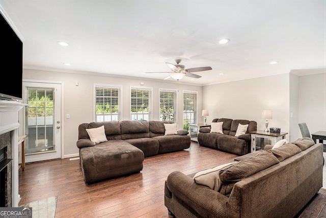 living room with ceiling fan, crown molding, and dark wood-type flooring