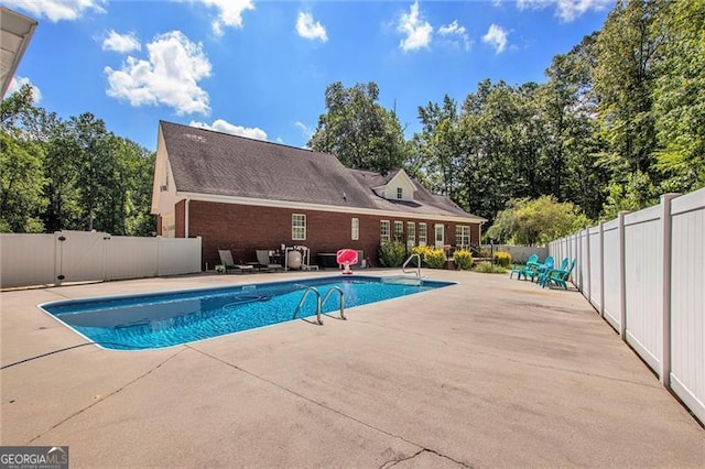 view of swimming pool featuring a patio area