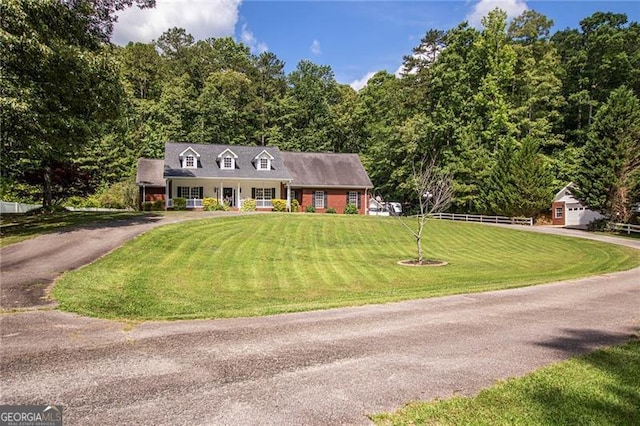 cape cod house with a front yard