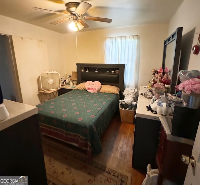 bedroom featuring ceiling fan and dark wood-type flooring