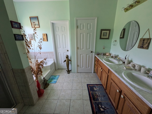 bathroom with tile patterned floors, dual vanity, and a bath