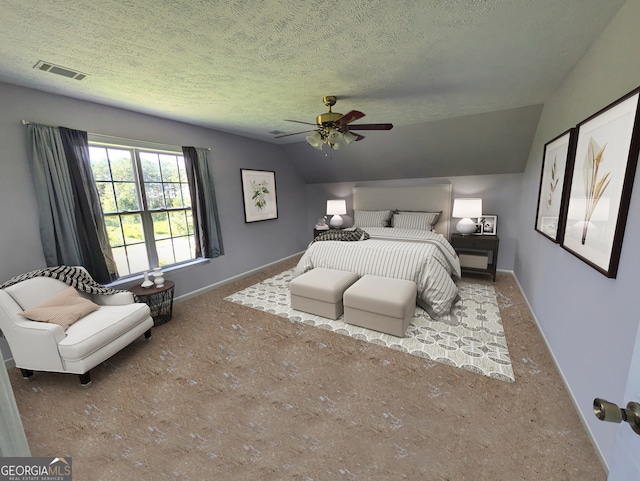 bedroom with a textured ceiling, ceiling fan, and vaulted ceiling