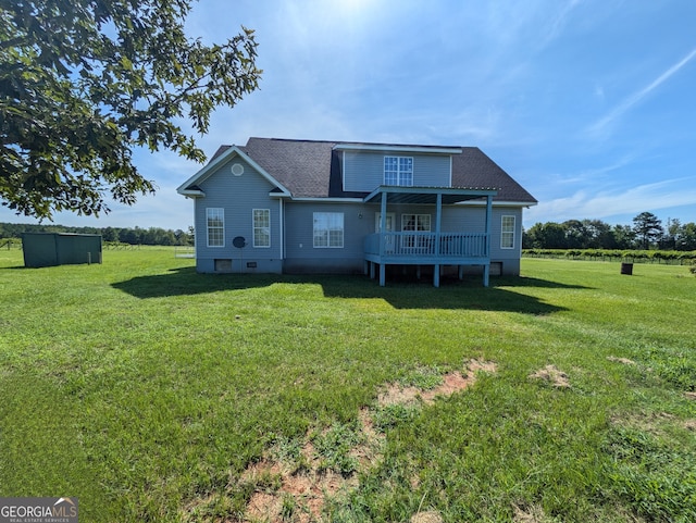 rear view of house with a lawn