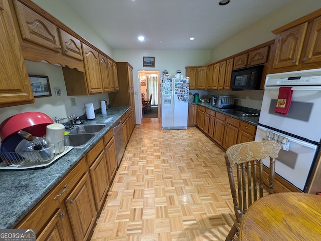 kitchen with light parquet floors, sink, and black appliances