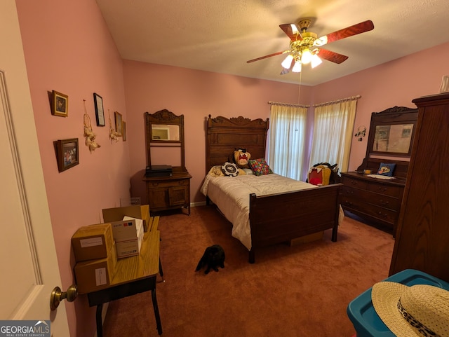 carpeted bedroom featuring a textured ceiling and ceiling fan